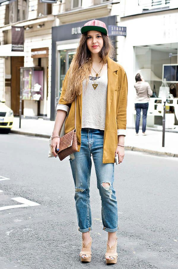The model in Boyfriend jeans and an autumn toned blazer.