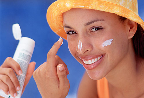 Girl applying sunscreen 