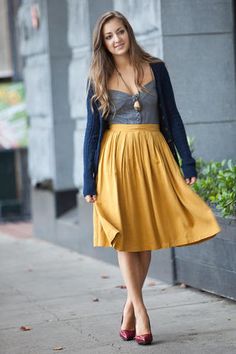 Midi skirt paired with grey top and blue cardign