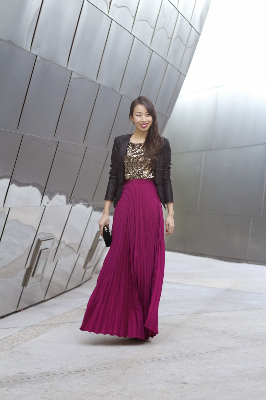 The model in black blazer with violet maxi skirt.