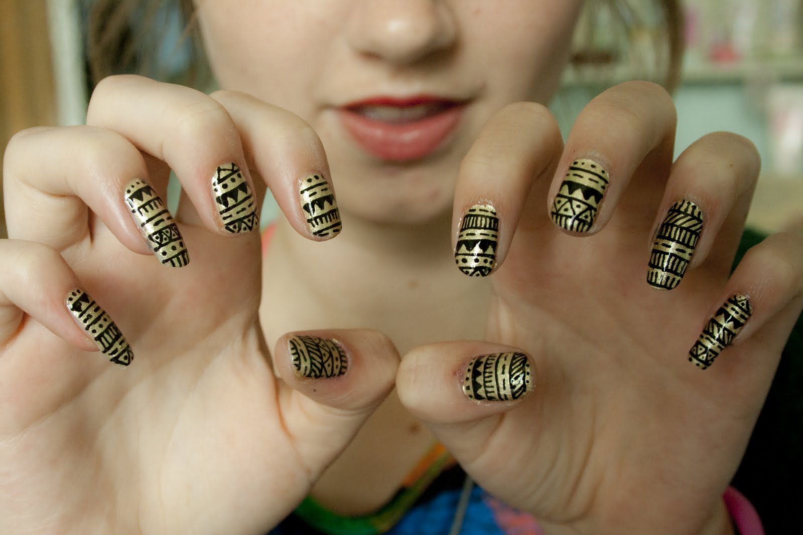 The girl with Black and Gold Aztec Nail Design.