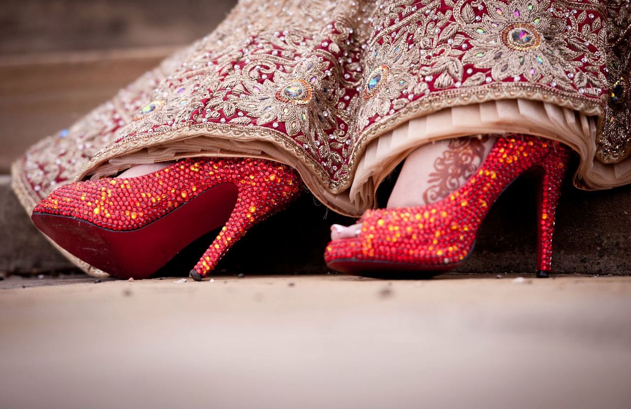 Indian bride wearing red shoes.